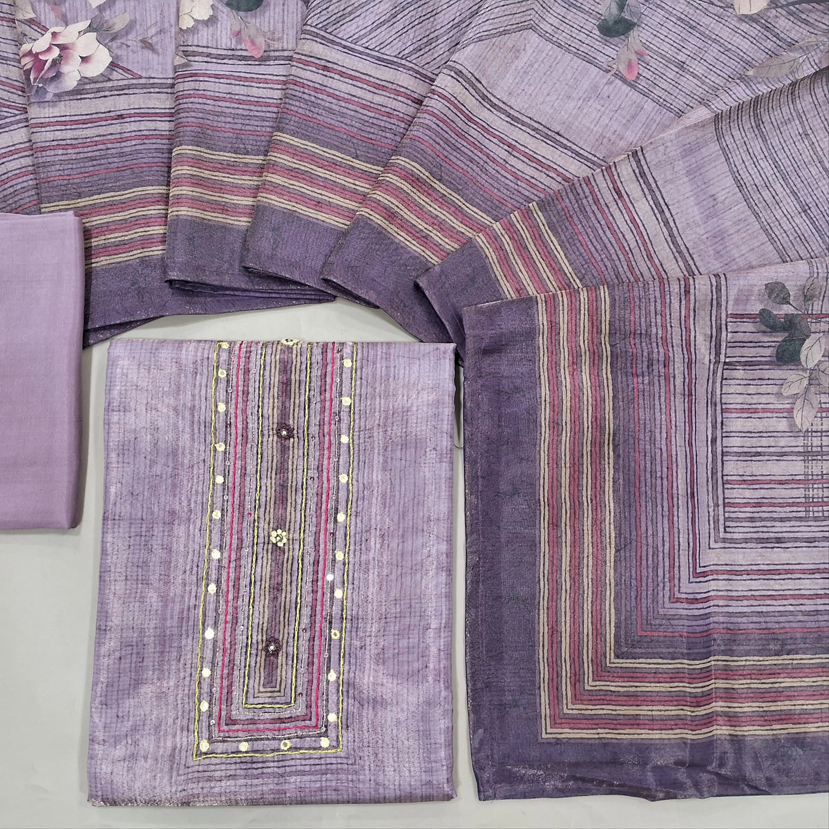 Lavender with golden tint digital printed tissue silk cotton unstitched salwar material, faux mirror& sequins work on yoke(thin fabric, lining needed)matching santoon bottom, digital printed tissue silk cotton dupatta. CODE SP242823