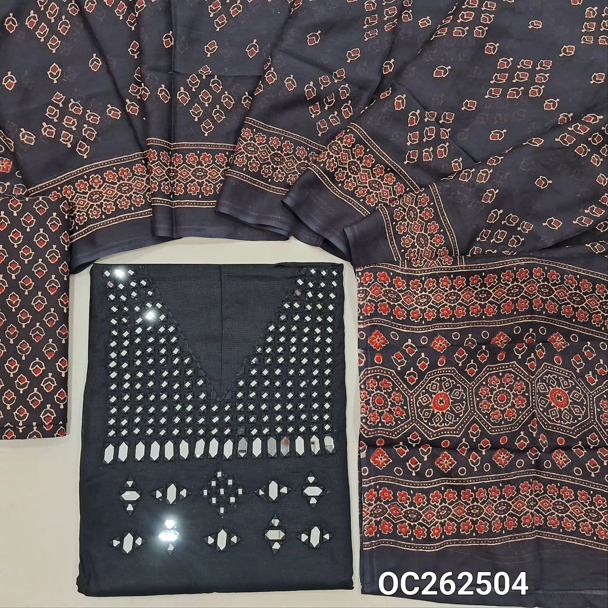 Black silk cotton unstitched salwar material,real mirror and thread work on yoke,(lining needed)black block printed pure cotton bottom,ajrak block printed full length mul cotton dupatta. OC262504