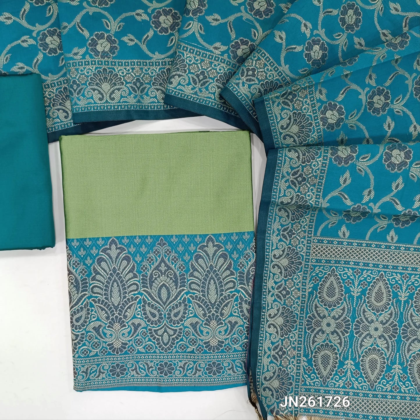 Sage green premium silk cotton unstitched salwar material, brocade weaving on daman,(Lining needed)turquoise blue silk cotton bottom, brocade weaving on silk cotton full length dupatta with rich pallu and tassles. JN261726