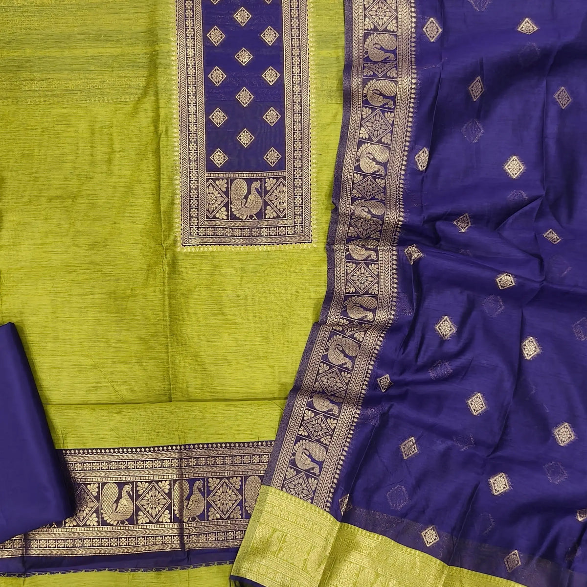 Leafy green and dark purple premium silk cotton benarasi zari woven unstitched salwar material, zari weaving on yoke&daman(Lightweight, Lining Needed)matching silk cotton bottom, zari wove silk cotton dupatta. SP261611