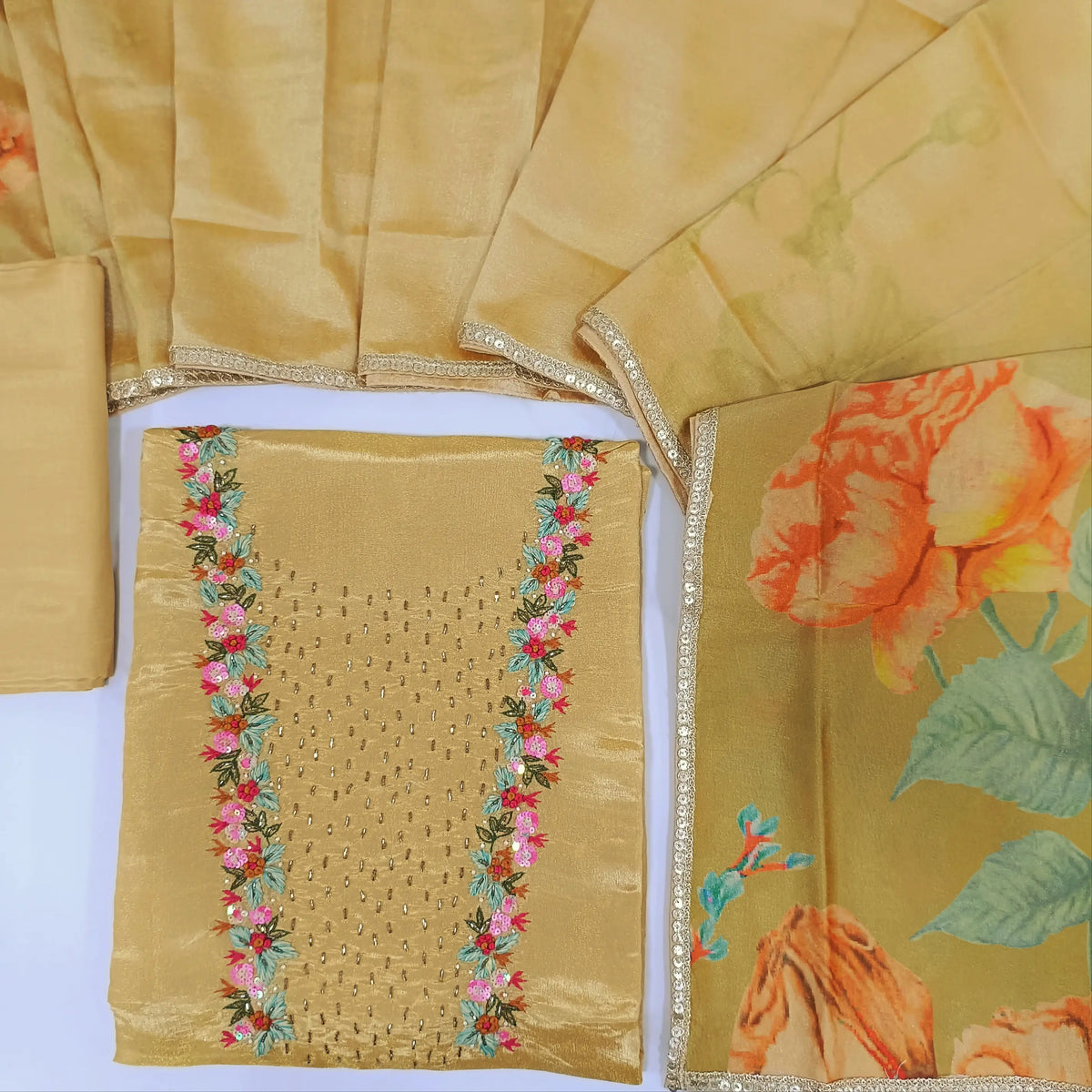 Beige with golden tint floral printed designer tissue silk cotton unstitched salwar material, zari& sequins work on yoke(lining needed)matching santoon bottom, floral printed soft tissue silk cotton dupatta with gold tissue borders. CODE AG242011