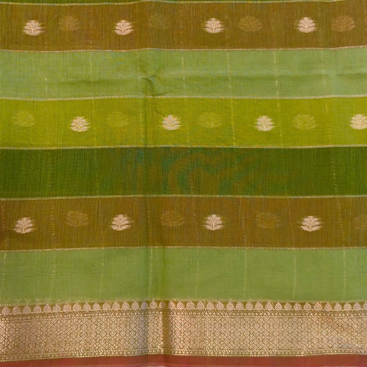 Multicoloured (Light & dark green)soft silk cotton saree with zari woven checks & buttas all over, zari woven double side borders, tissue pallu,multicoloured running blouse with borders & buttas. NS30