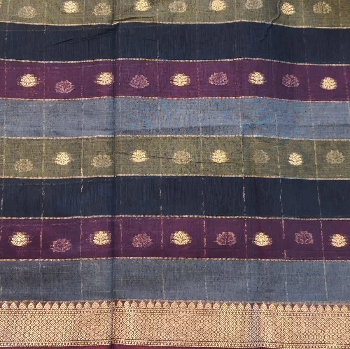 Multicoloured (Blue,purple & green)soft silk cotton saree with zari woven checks & buttas all over, zari woven double side borders, tissue pallu,multicoloured running blouse with borders & buttas. NS29