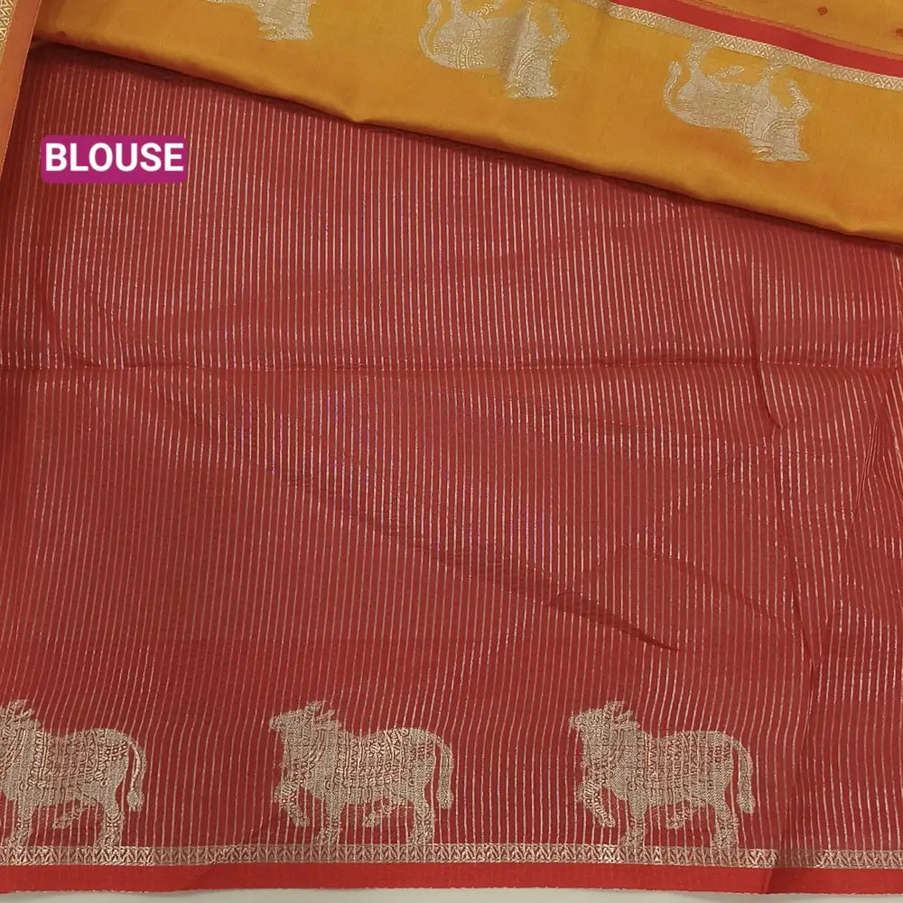 Light orange with reddish maroon fancy silk cotton saree with thread woven buttas all over the body of the saree, double side borders with pichwai zari short pallu and zari striped blouse with cow motif weaving. CODE NS05