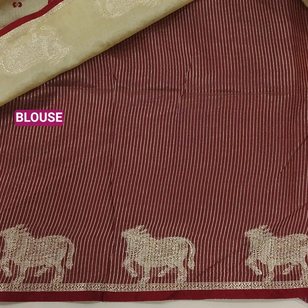 Beige with dark maroon fancy silk cotton saree with thread woven buttas all over the body of the saree, double side borders with pichwai zari short pallu and zari striped blouse with cow motif weaving. CODE NS08