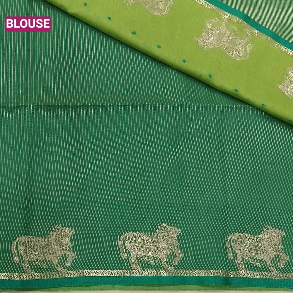 Light green with turquoise green fancy silk cotton saree with thread woven buttas all over the body of the saree, double side borders with pichwai zari short pallu and zari striped blouse with cow motif weaving. CODE NS06