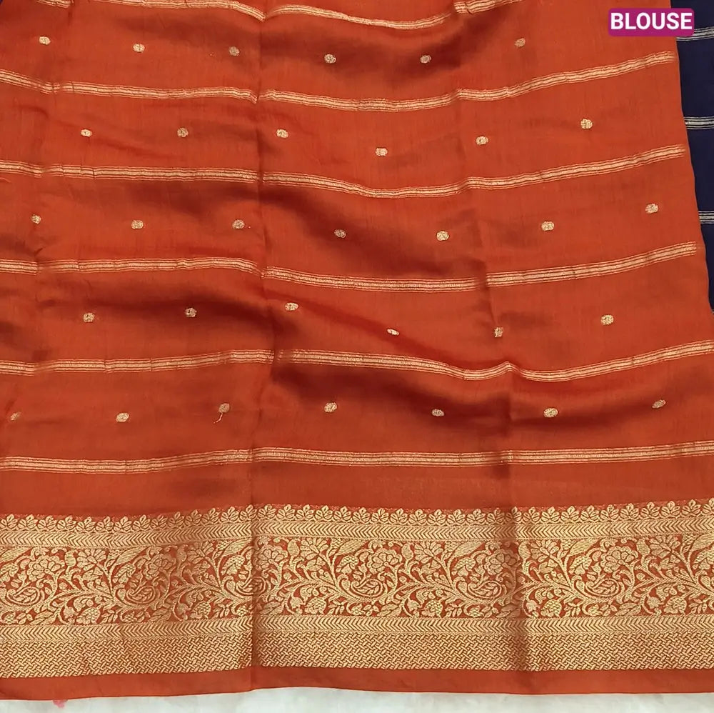 Navy Blue fancy silk saree (soft, silky) with banarasi zari woven double side borders zari woven butttas and stripes allover, contrast zari woven pallu, rust orange zari woven blouse with borders. NS44