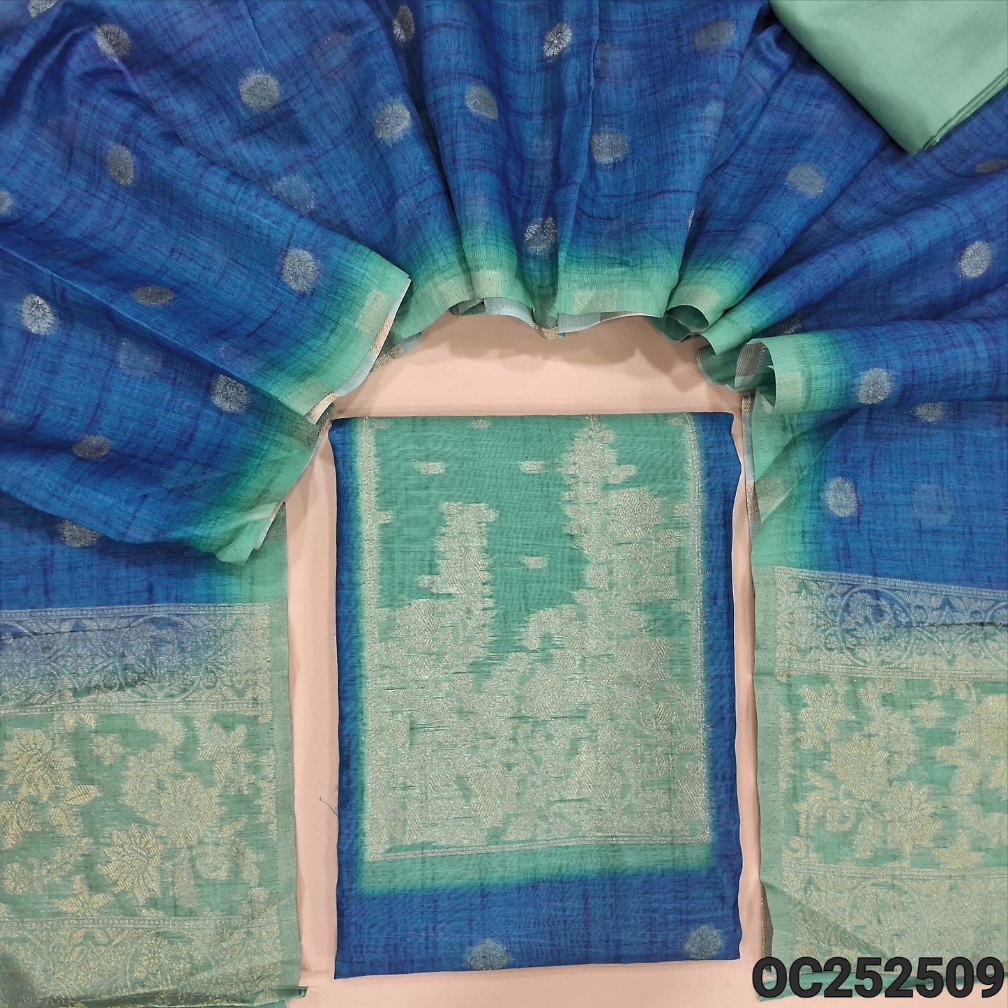 Turquoise Blue premium silk cotton unstitched salwar material,(thin, lining needed) turquoise green patch, zari weaving design on yoke, zari buttas on front, turquoise green spun cotton bottom, Dual shaded silk cotton dupatta with zari buttas. OC252509