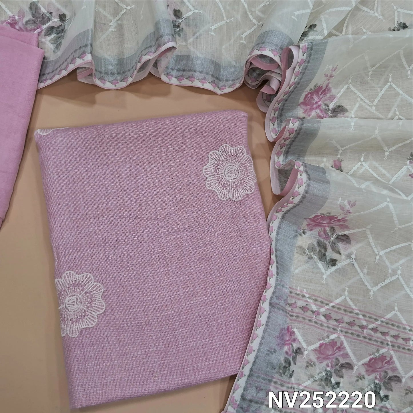 Pastel pink semi linen unstitched salwar material (textured,lining needed)thread embroidery on front,matching santoon bottom, rich embroidery work and floral printed semi linen dupatta. NV252220