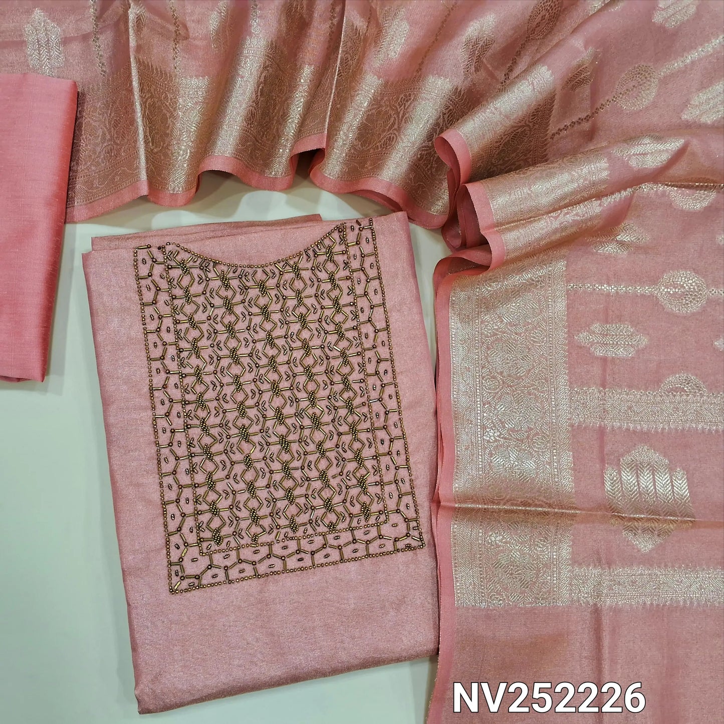 Peachish pink with golden tint tissue silk cotton unstitched salwar material, cut bead and sugar bead work on yoke ( Lining Needed) Matching silk cotton bottom, rich benarasi woven tissue silk cotton full length dupatta with borders and tassles. NV252226