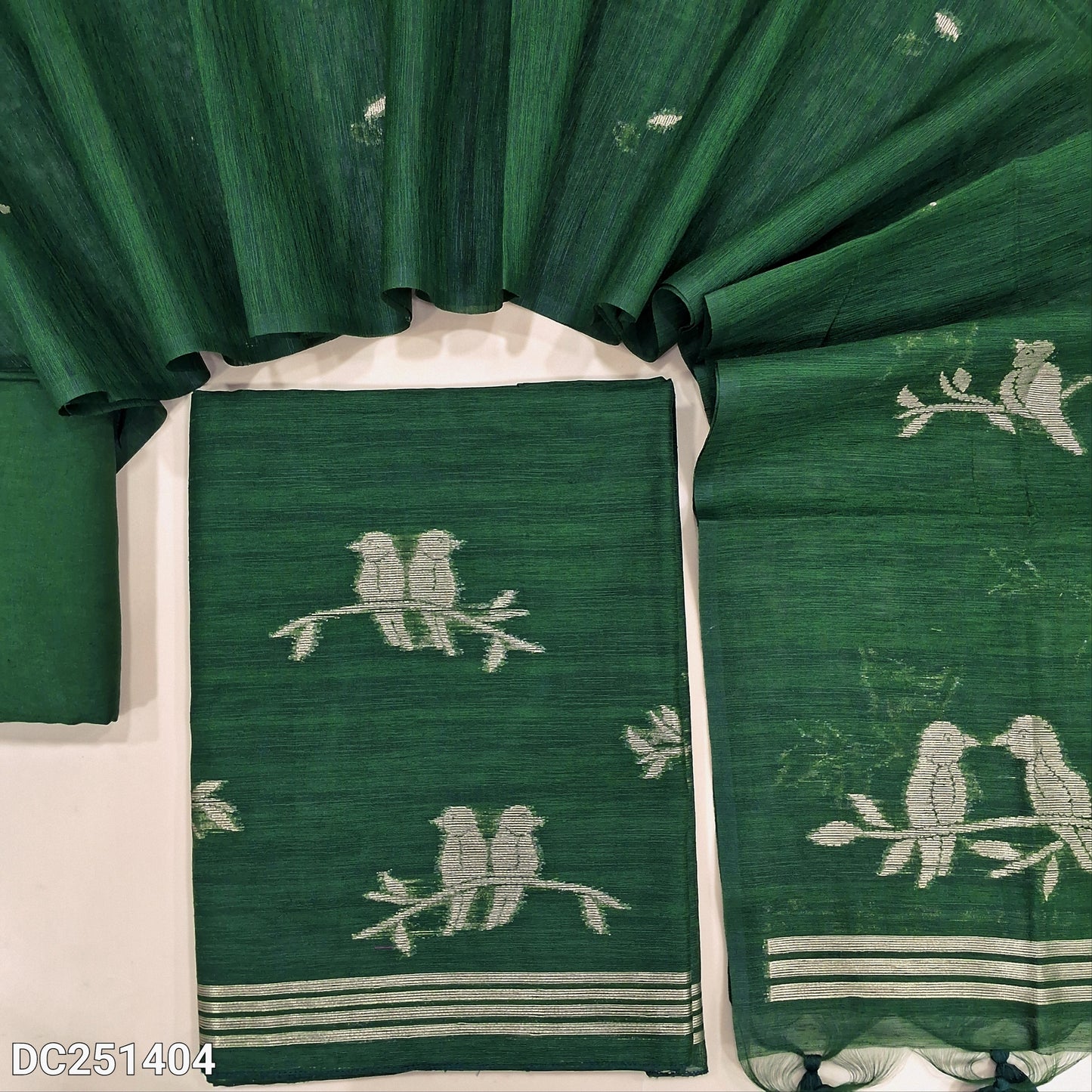 Designer bottle Green jamdani woven premium tussar silk unstitched salwar material, (textured, lining needed) golden zari weaving on daman, santoon bottom, full length jamdani woven tussar silk dupatta with tassels. DC251404