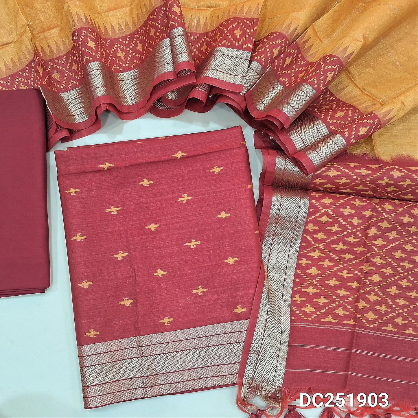 Designer reddish maroon premium silk cotton unstitched salwar material (lining needed) ikkat weaving buttas allover, zari daman, matching silk cotton bottom, zari checks, ikat woven buttas on dual shade silk cotton full length dupatta. DC251903