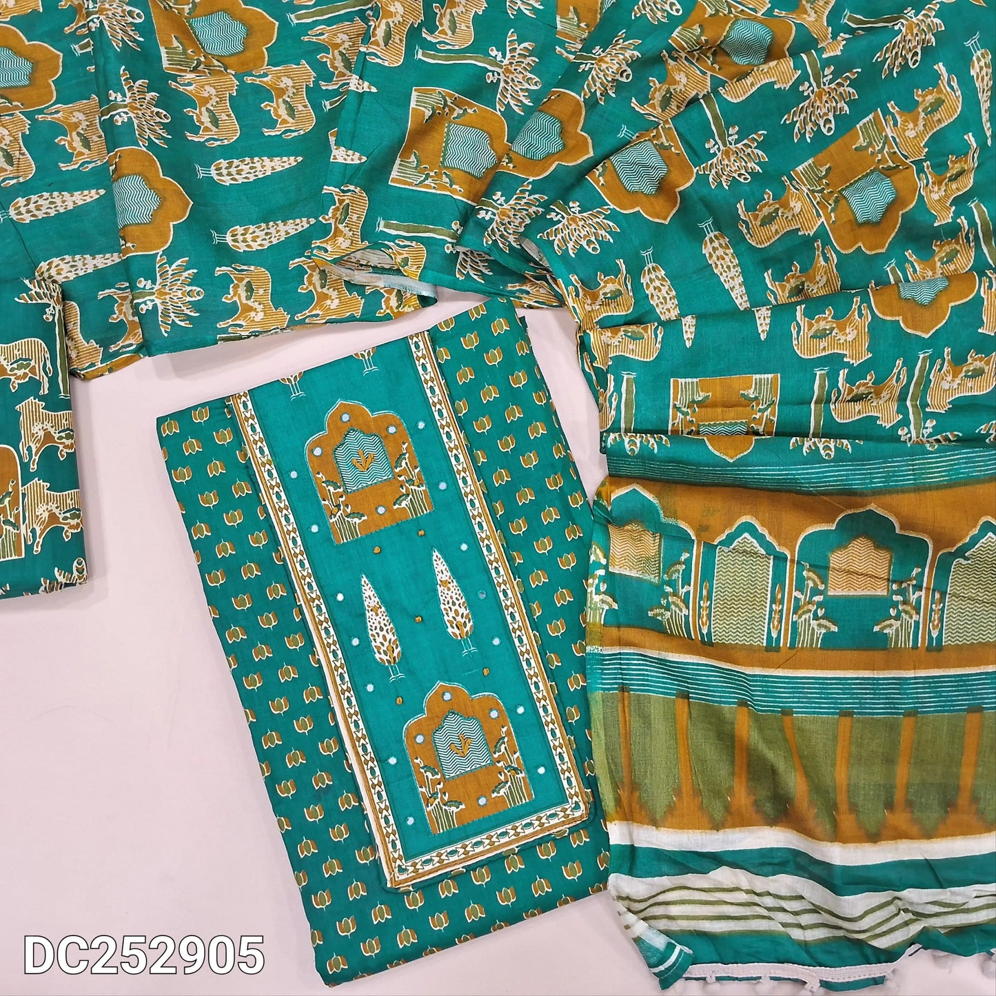 Printed teal Green pure cotton unstitched salwar material (lining optional) thread work on yoke, printed cotton bottom, printed mul cotton dupatta with pompom tapings.DC252905