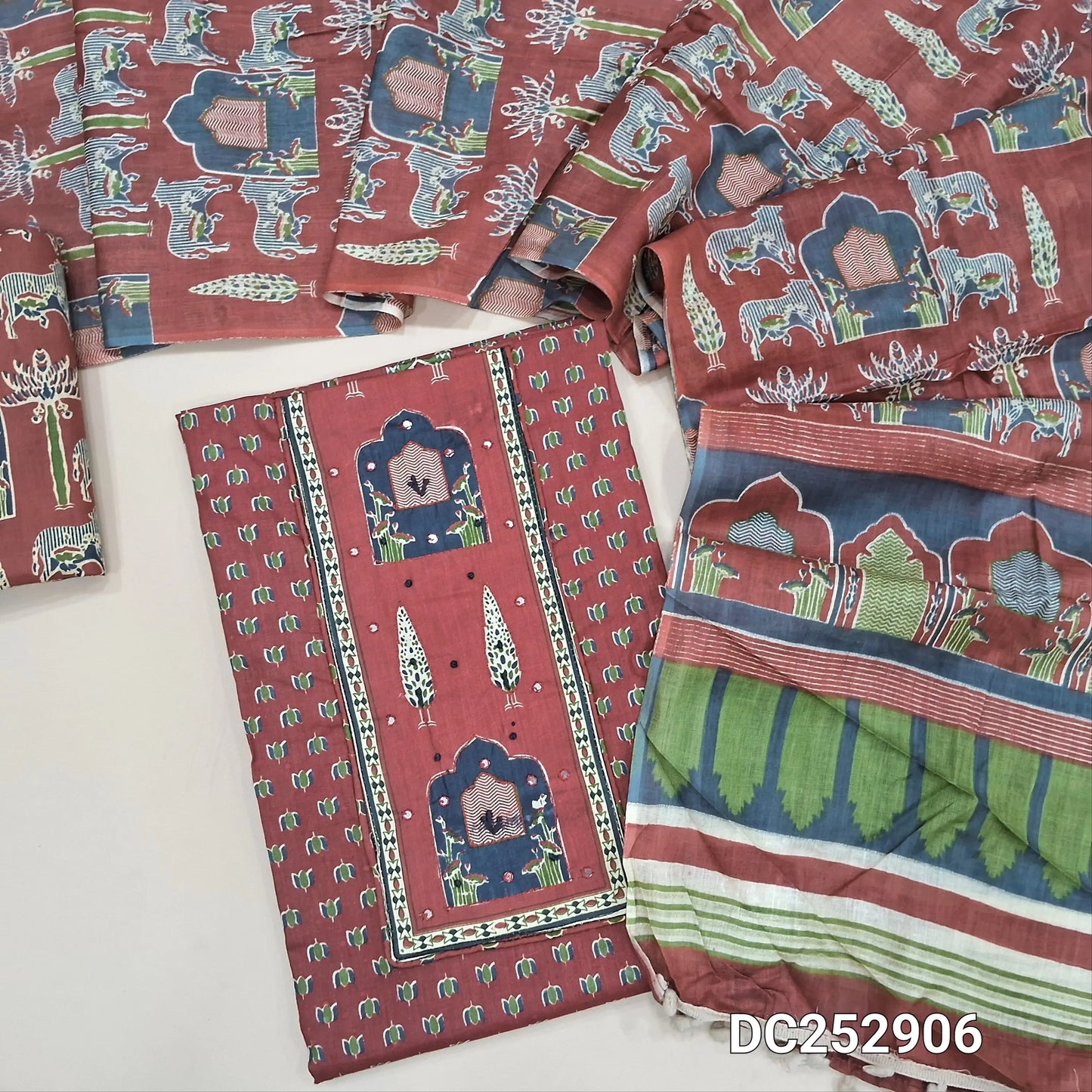 Printed dark Maroon pure cotton unstitched salwar material (lining optional) thread work on yoke, printed cotton bottom, printed mul cotton dupatta with pompom tapings. DC252906