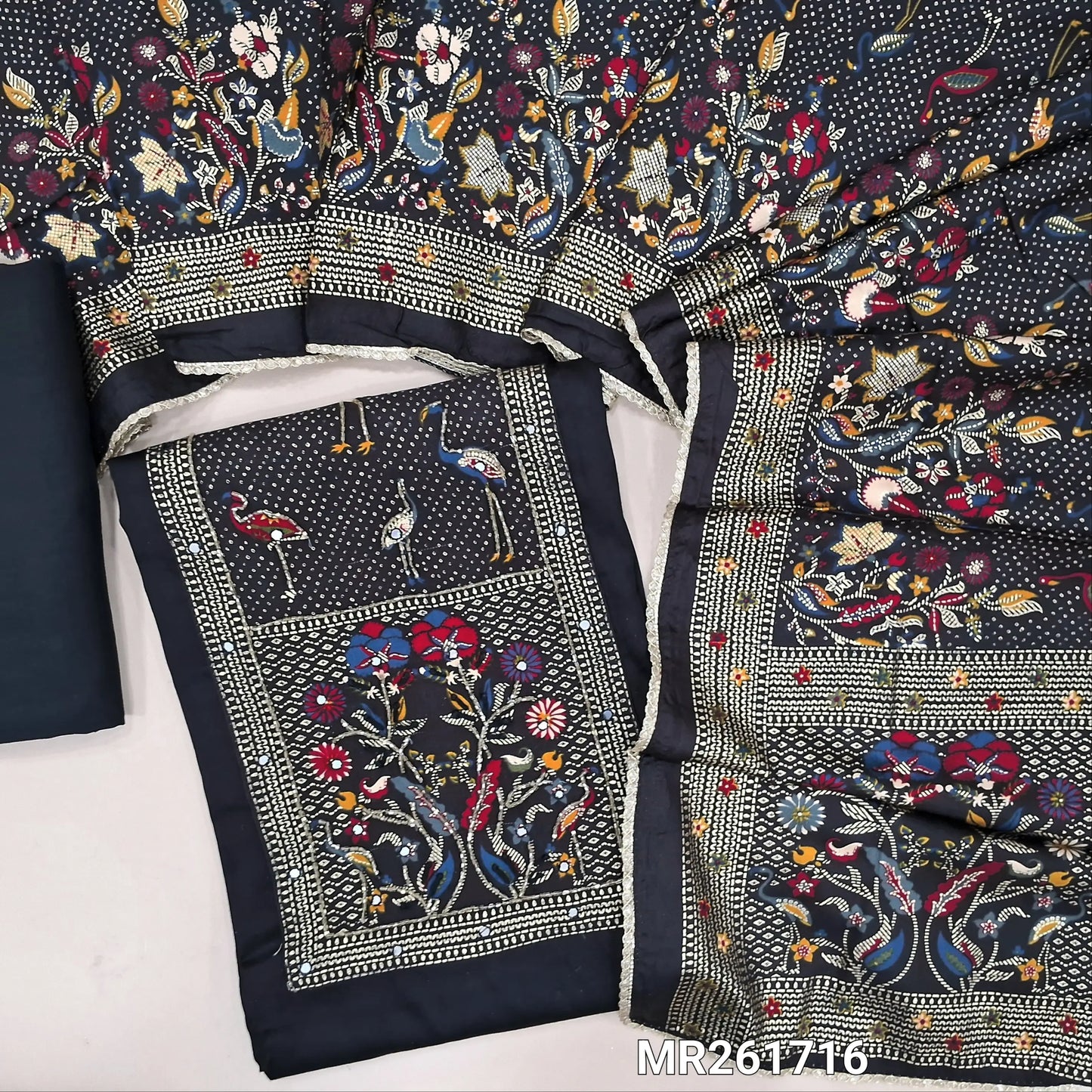 Black glazed cotton unstitched salwar material,digital printed yoke with cut bead and embroidery work, faux mirror on front,(lining optional)matching spun cotton bottom,printed short width pure modal cotton dupatta. MR261716