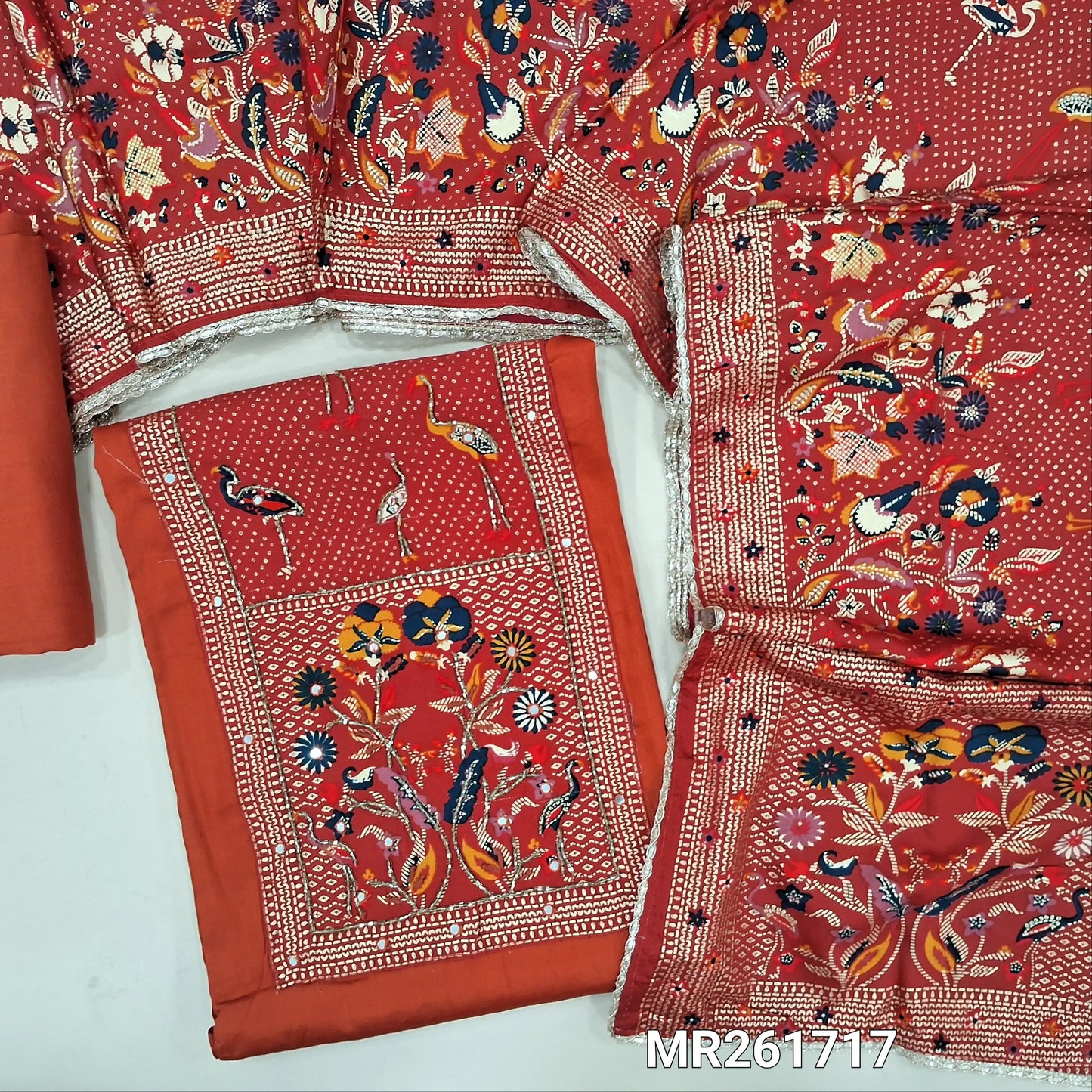 Rust orange glazed cotton unstitched salwar material,digital printed yoke with cut bead and embroidery work, faux mirror on front,(lining optional)matching spun cotton bottom,printed short width pure modal cotton dupatta. MR261717