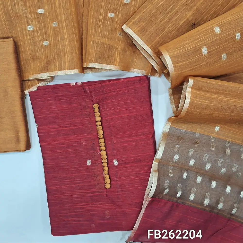Brick red slub silk cotton unstitched salwar material, potli buttons on yoke, zari buttas all over, organza fabric with zari woven on daman,(lining needed)mehandhi yellow silk cotton bottom, zari buttas on silk cotton dupatta with organza pallu. FB262204