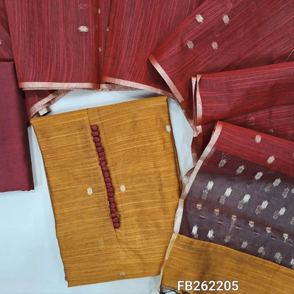 Mehandhi yellow slub silk cotton unstitched salwar material, potli buttons on yoke, zari buttas all over, organza fabric with zari woven on daman,(lining needed)maroon silk cotton bottom, zari buttas on silk cotton dupatta with organza pallu. FB262205