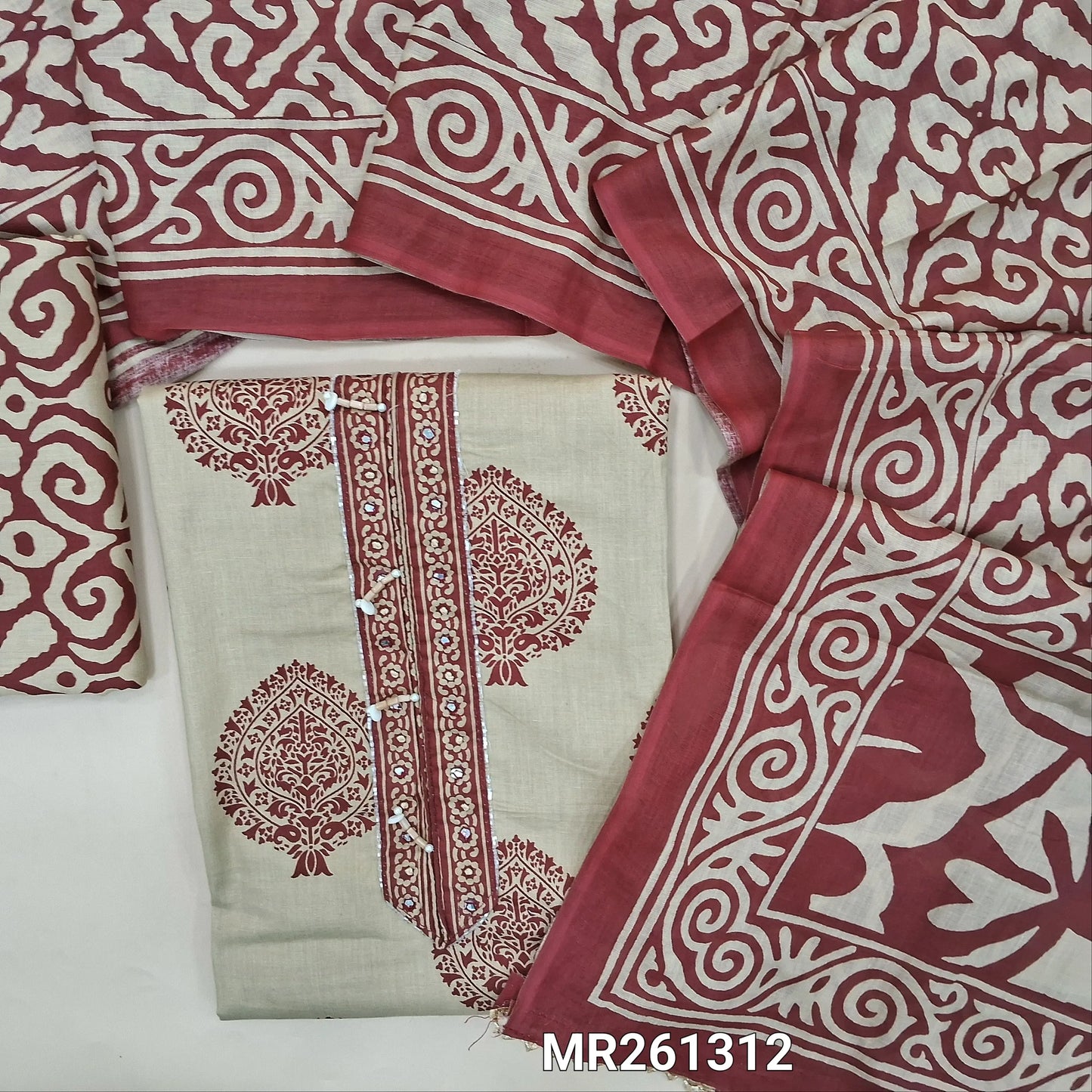 Light beige base printed pure soft cotton unstitched salwar material,cut bead and faux mirror on yoke(lining optional)printed cotton bottom, printed mul cotton dupatta. MR261312
