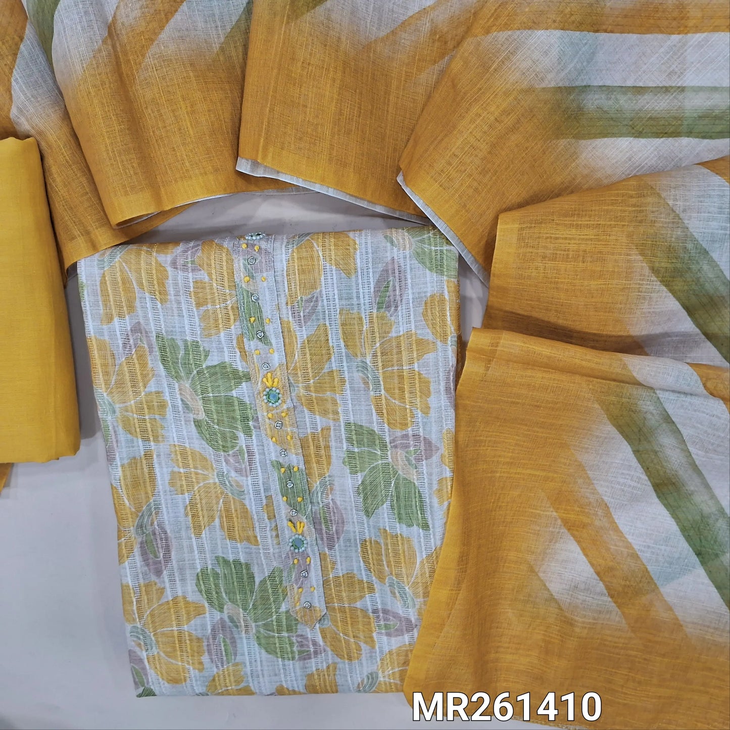 Half white jakard linen unstitched salwar material,zarodzi, french knot and mirror work on yoke, pastel shaded floral design all over,(lining needed)yellow cotton bottom, Lehariya printed semi linen dupatta. MR261410