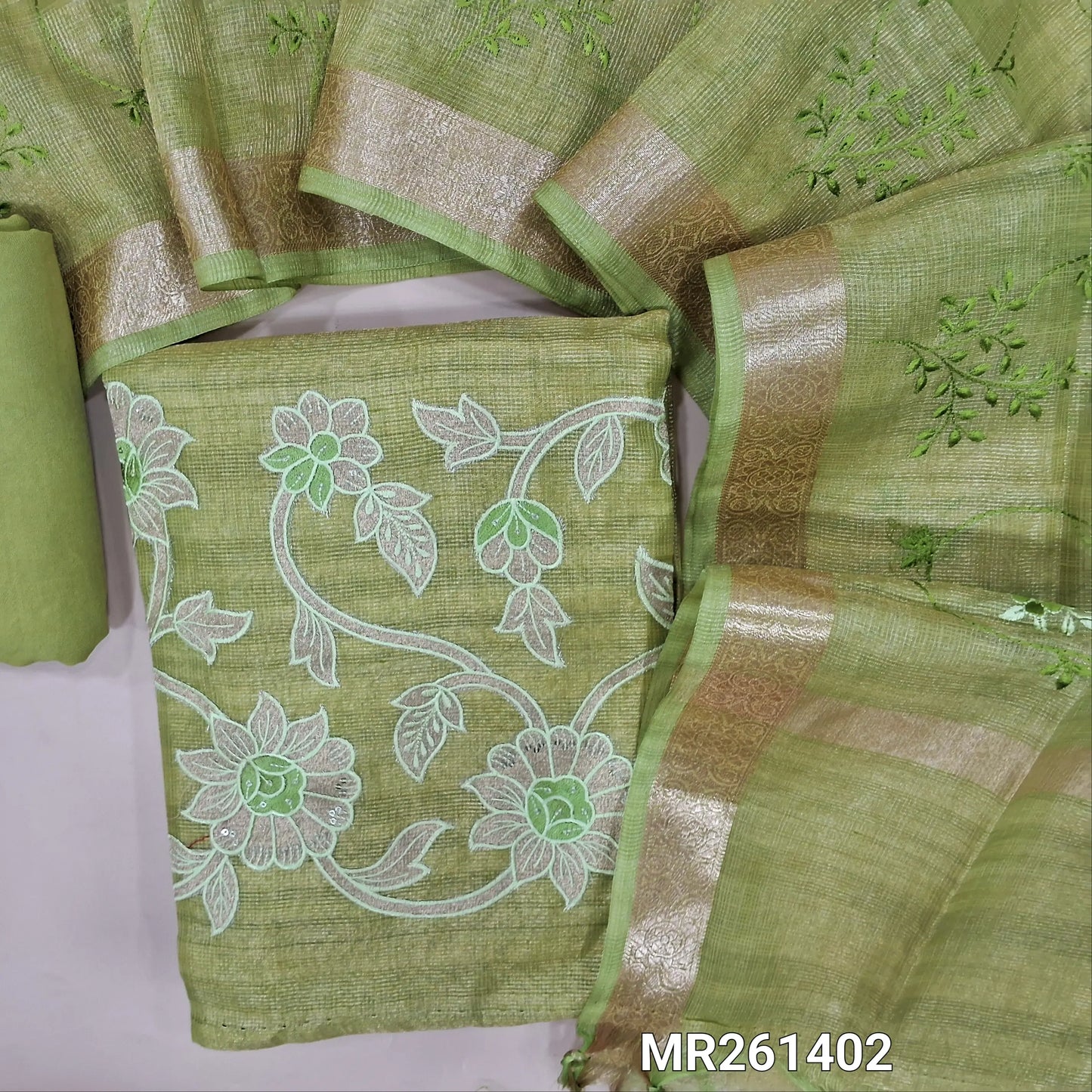 Pastel green with golden tint tissue kota unstitched salwar material (lining needed) embroidery work on front, thread embroidery and applique work on daman ,matching santoon bottom, rich embroidery work on tissue kota dupatta with zari borders. MR261402