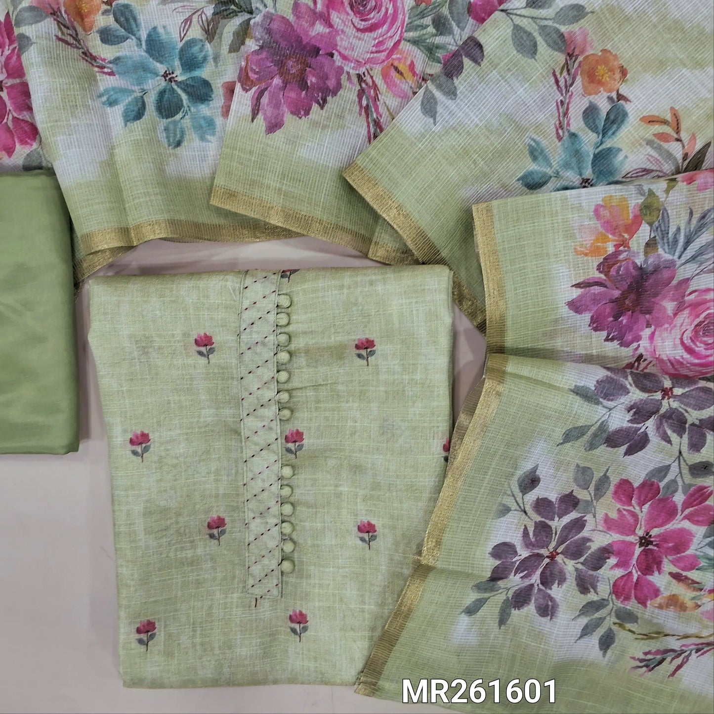 Pastel green tissue silk cotton unstitched salwar material,potli buttons on yoke, floral printed all over, (lining needed)matching silky bottom,digital printed tissue silk cotton dupatta with tissue borders. MR261601