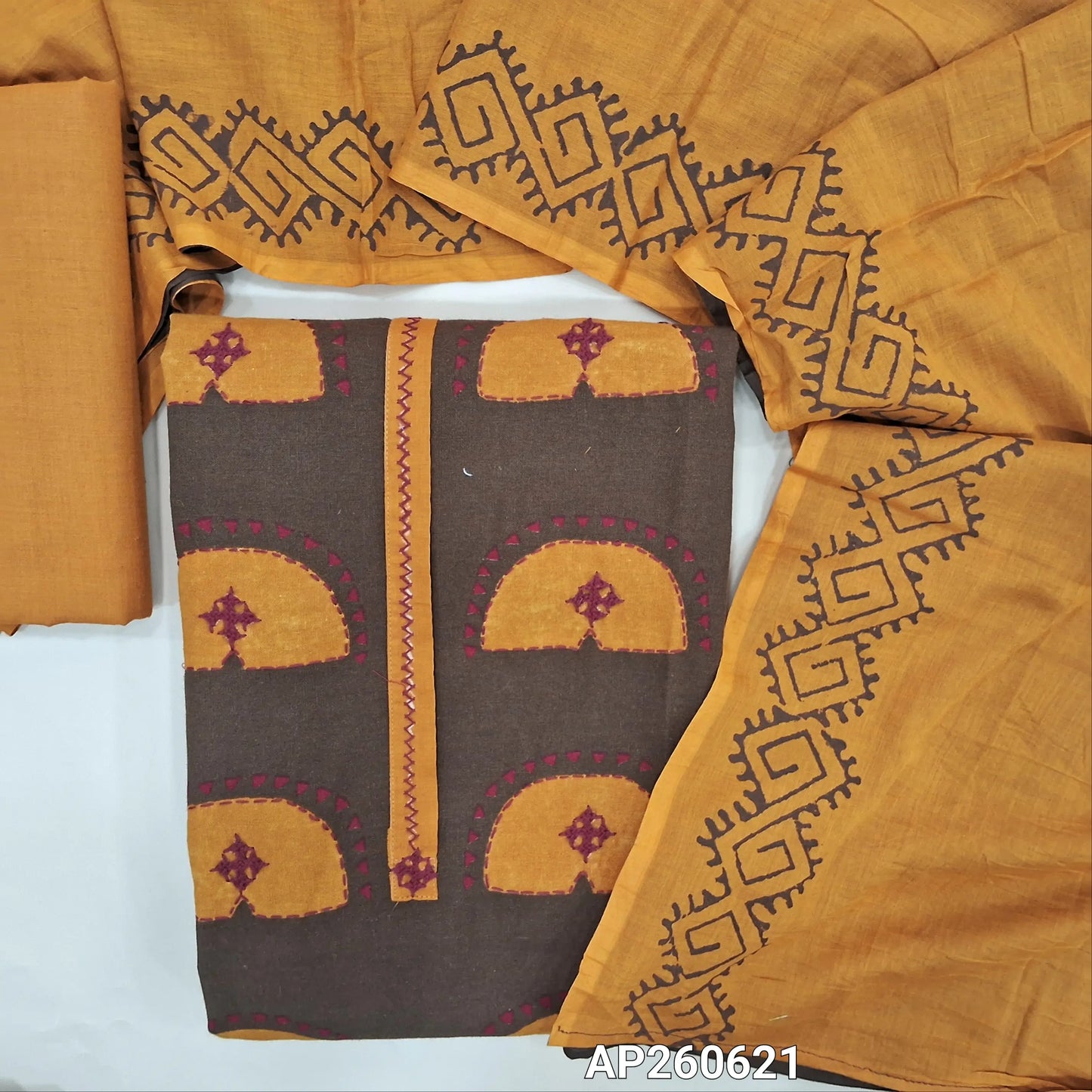 Brown printed premium cotton unstitched salwar material, block printed yoke with hand embroidery(lining needed) mehandhi yellow cotton bottom, hand block printed dual shaded mul cotton dupatta. AP260621