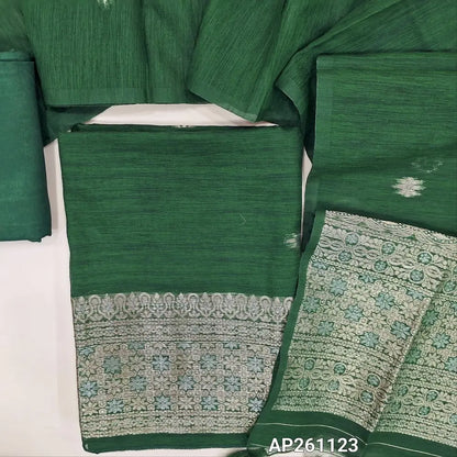 Bottle green premium tussar silk unstitched salwar material, buttas on front,gold and silver zari weaving on daman,(textured, lining needed)santoon bottom,buttas on tussar silk dupatta with gold and silver zari weaving pallu with tassles. AP261123