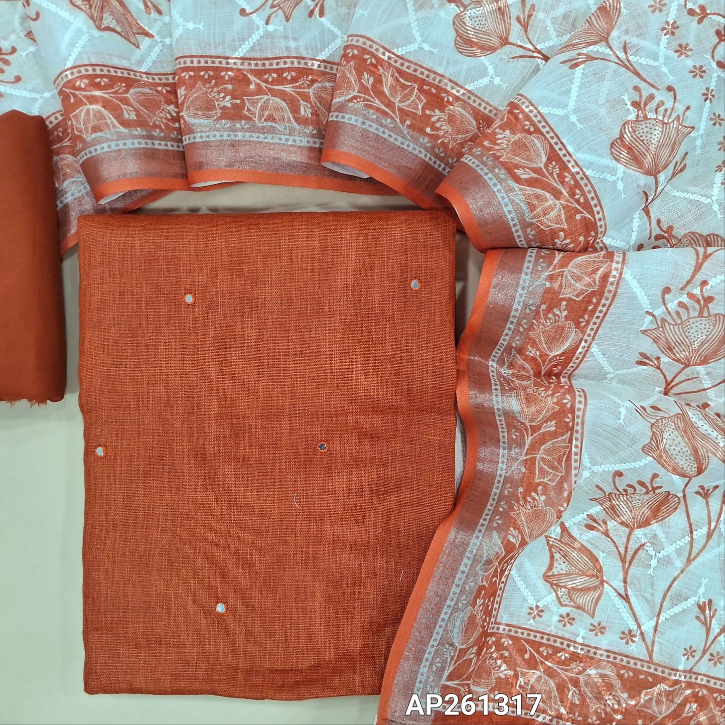 Brick red semi linen unstitched salwar material,faux mirror work on front (textured, lining optional) silky bottom, self embroidery and printed on semi linen dupatta. AP261317