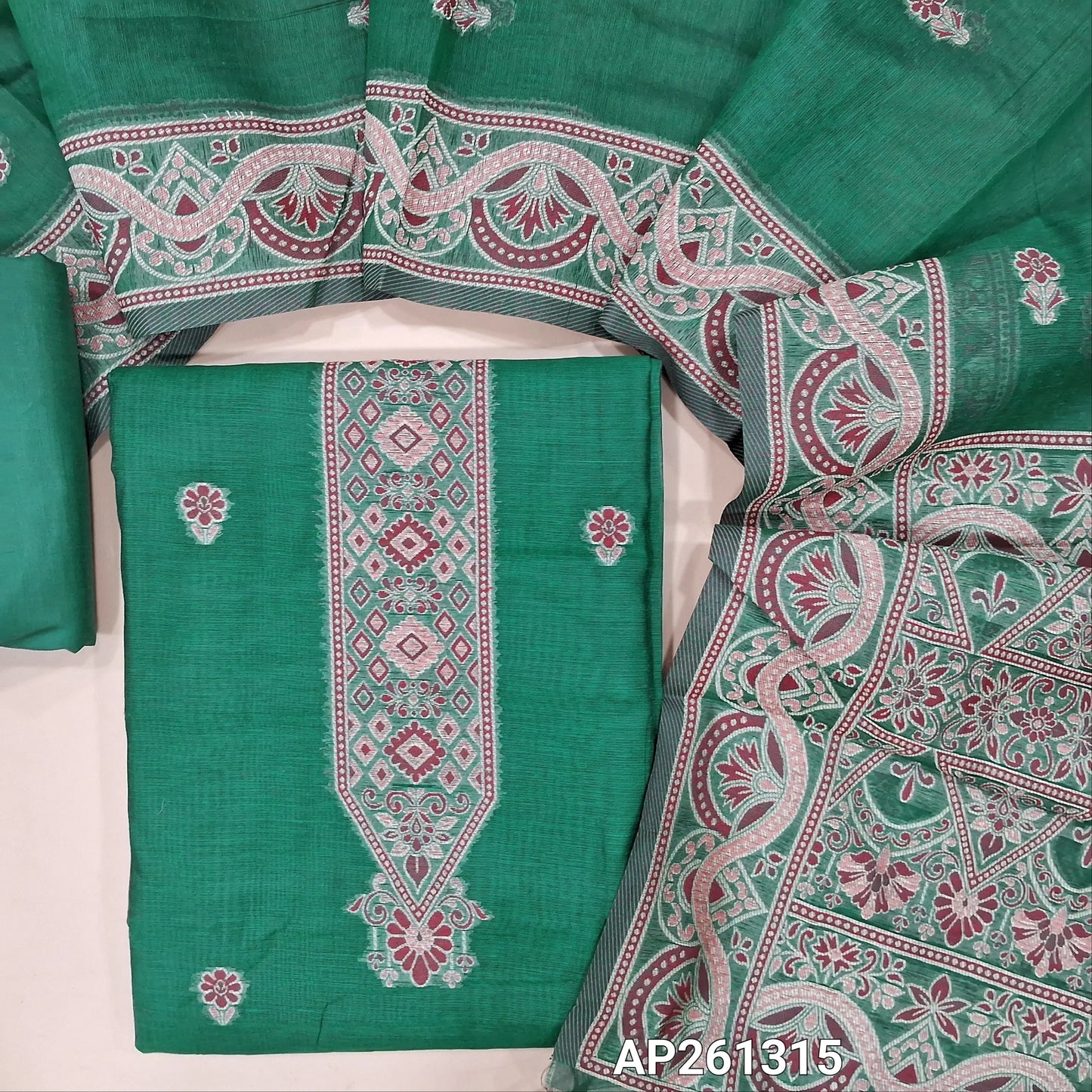 Teal green silk cotton unstitched salwar material, floral buttas on front,thread weaving design on yoke and daman, (Silky, Lining Needed) silky bottom,buttas on silk cotton dupatta with rich thread weaving on pallu and borders. AP261315