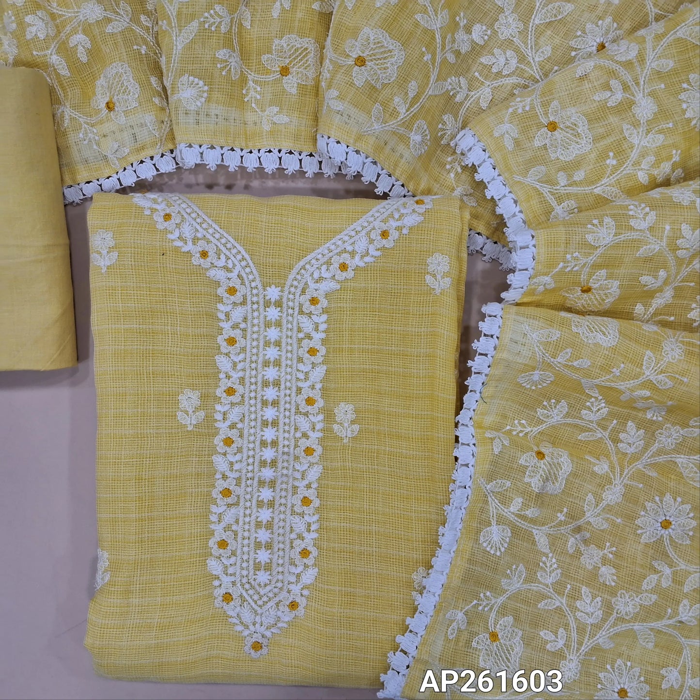 Pastel yellow premium kota unstitched salwar material, embroidery work on yoke and front, self checked all over (Lining Needed) matching fabric provided for lining, NO BOTTOM, rich thread embroidery work on kota dupatta with lace tapping. AP261603