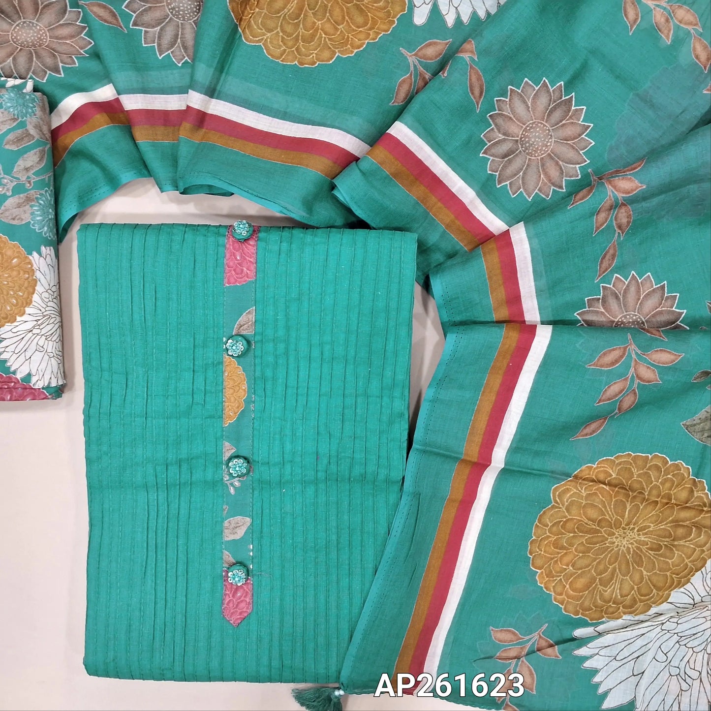 Pastel blue pure cotton unstitched salwar material,simple yoke with fancy buttons, pintex detailing on front,(lining needed) multicoloured printed cotton bottom,colorful floral printed mul cotton dupatta. AP261623