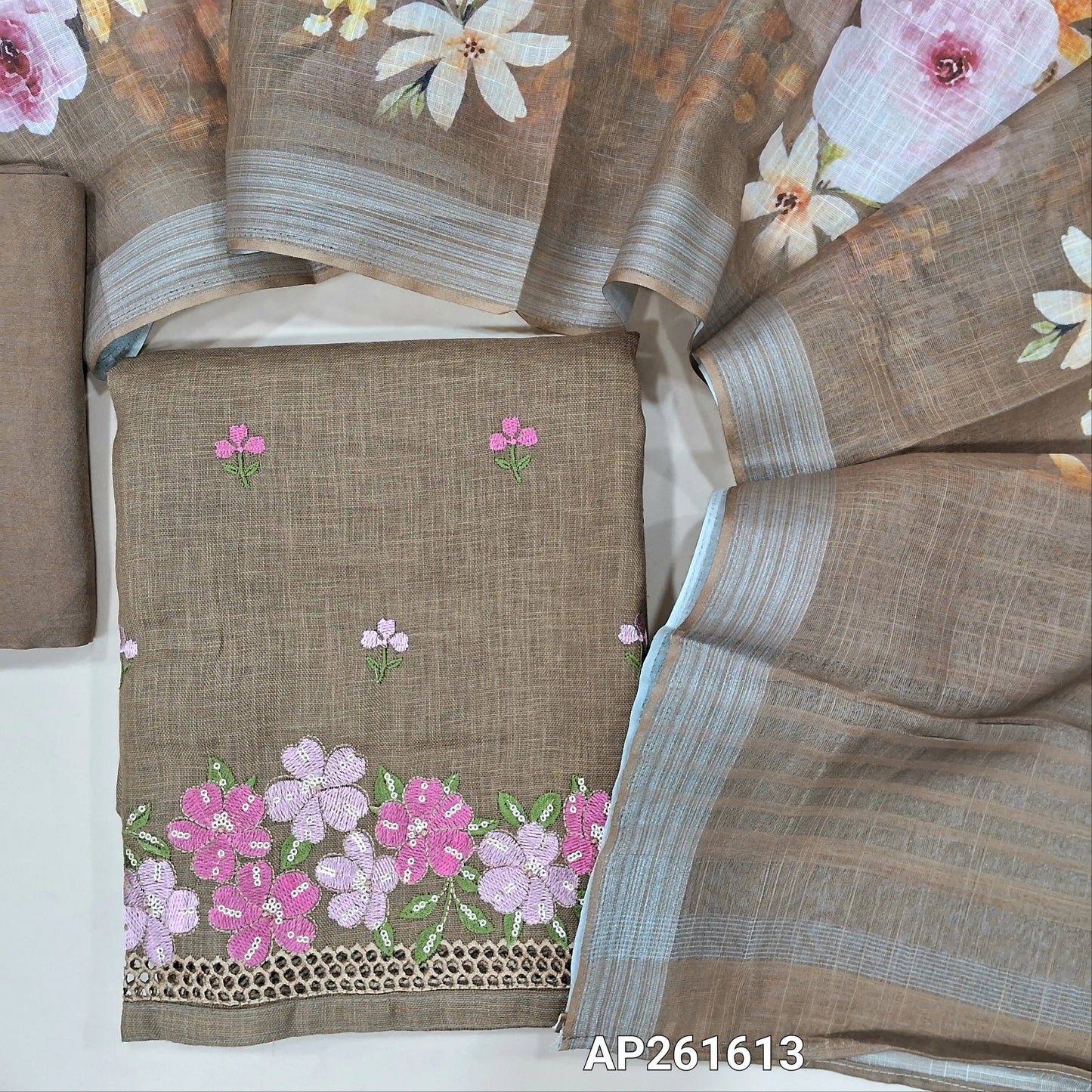 Light chocolate brown semi linen unstitched salwar material, floral embroidery on front,embroidery and cut work on daman,(textured, lining optional)santoon bottom,floral printed semi linen dupatta with silver tissue borders. AP261613