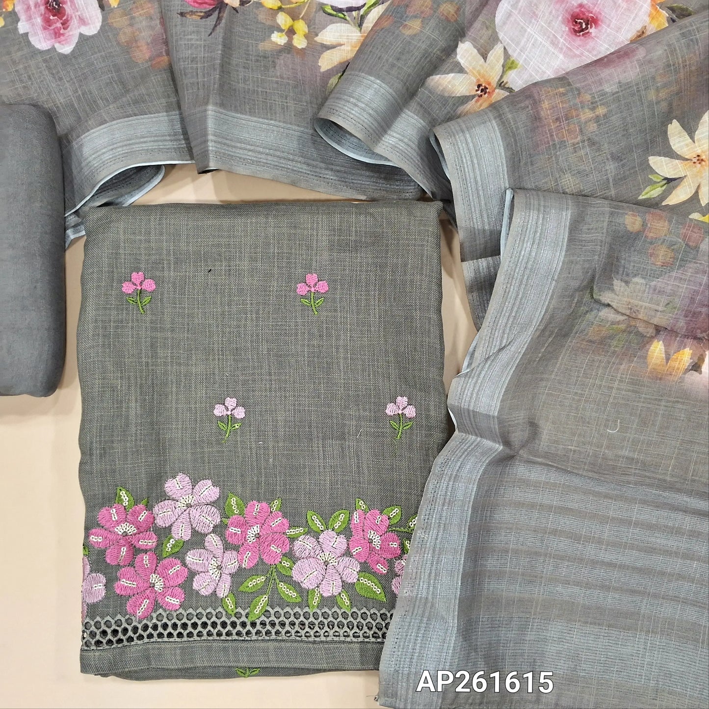 Light grey semi linen unstitched salwar material, floral embroidery on front,embroidery and cut work on daman,(textured, lining optional)santoon bottom,floral printed semi linen dupatta with silver tissue borders. AP261615
