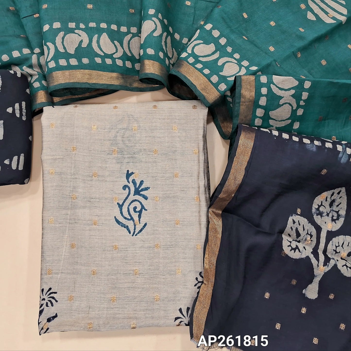 Light greyish beige block Printed soft silk cotton unstitched salwar material (lining needed) zari buttas all over, dark blue printed batik cotton bottom,zari buttas dual shaded silk cotton dupatta with gold tissue borders.(TAPING NEEDED) AP261815