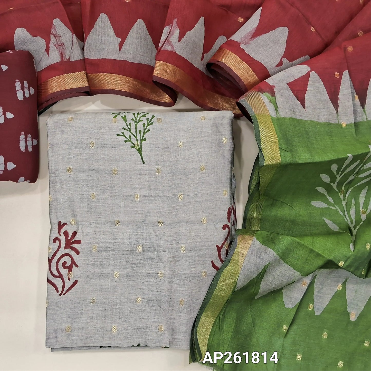 Light greyish beige block Printed soft silk cotton unstitched salwar material (lining needed) zari buttas all over, maroon printed batik cotton bottom,zari buttas dual shaded silk cotton dupatta with gold tissue borders.(TAPING NEEDED) AP261814