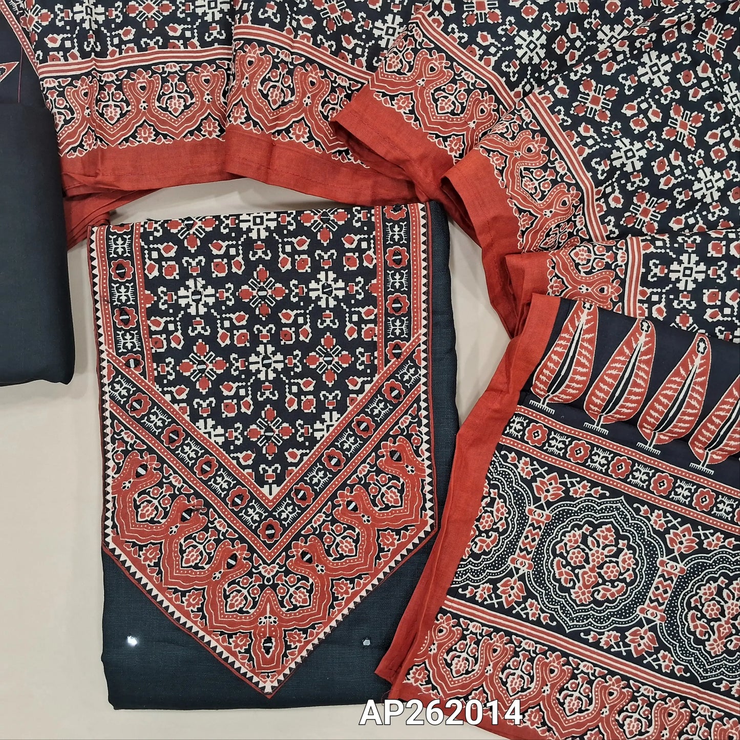 Black semi linen unstitched salwar material, ajrak yoke patch with real mirror,faux mirror work on front, (textured, lining needed)spun cotton bottom,ajral printed cotton dupatta. AP262014
