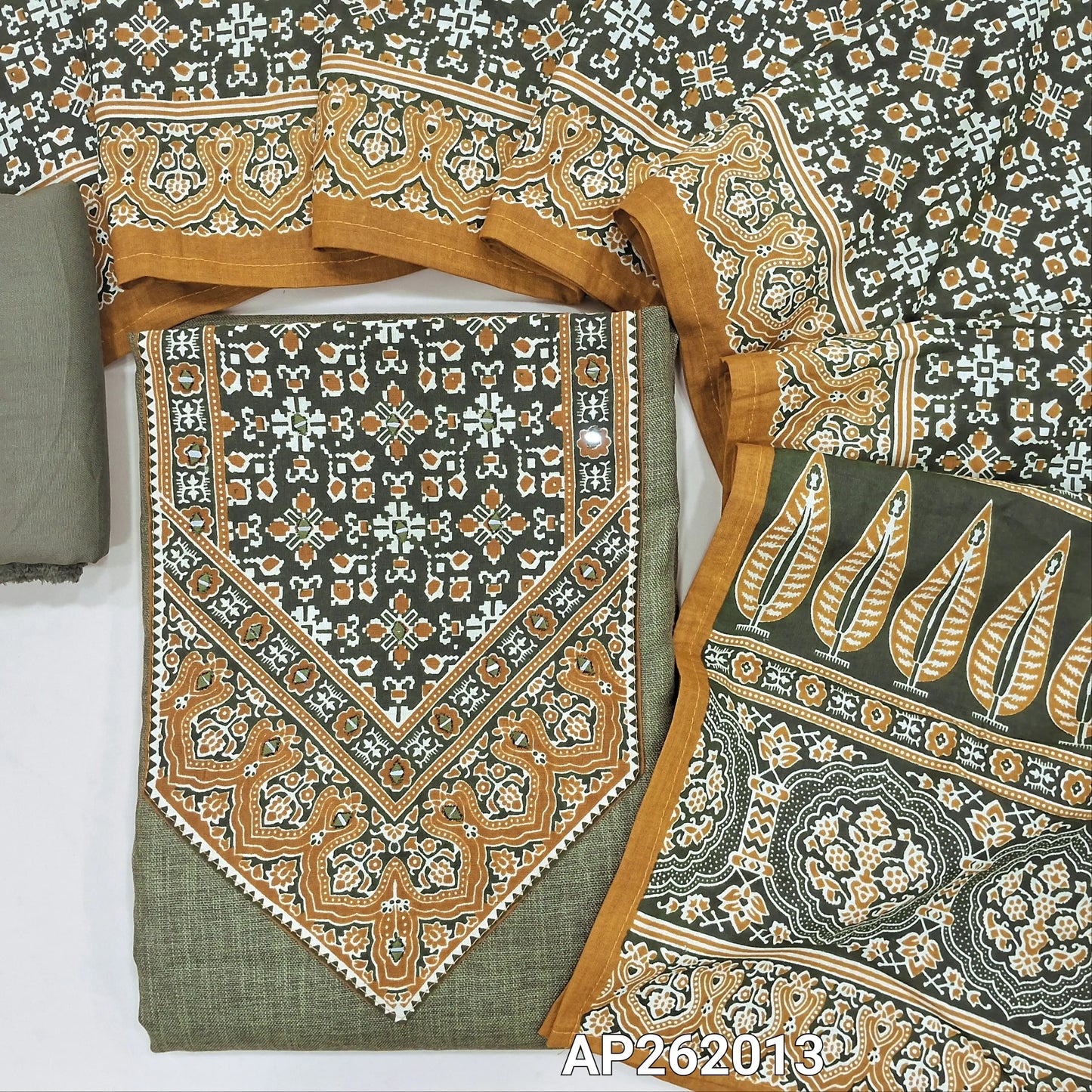 Dark olive green semi linen unstitched salwar material, ajrak yoke patch with real mirror,faux mirror work on front, (textured, lining needed)spun cotton bottom,ajral printed cotton dupatta. AP262013