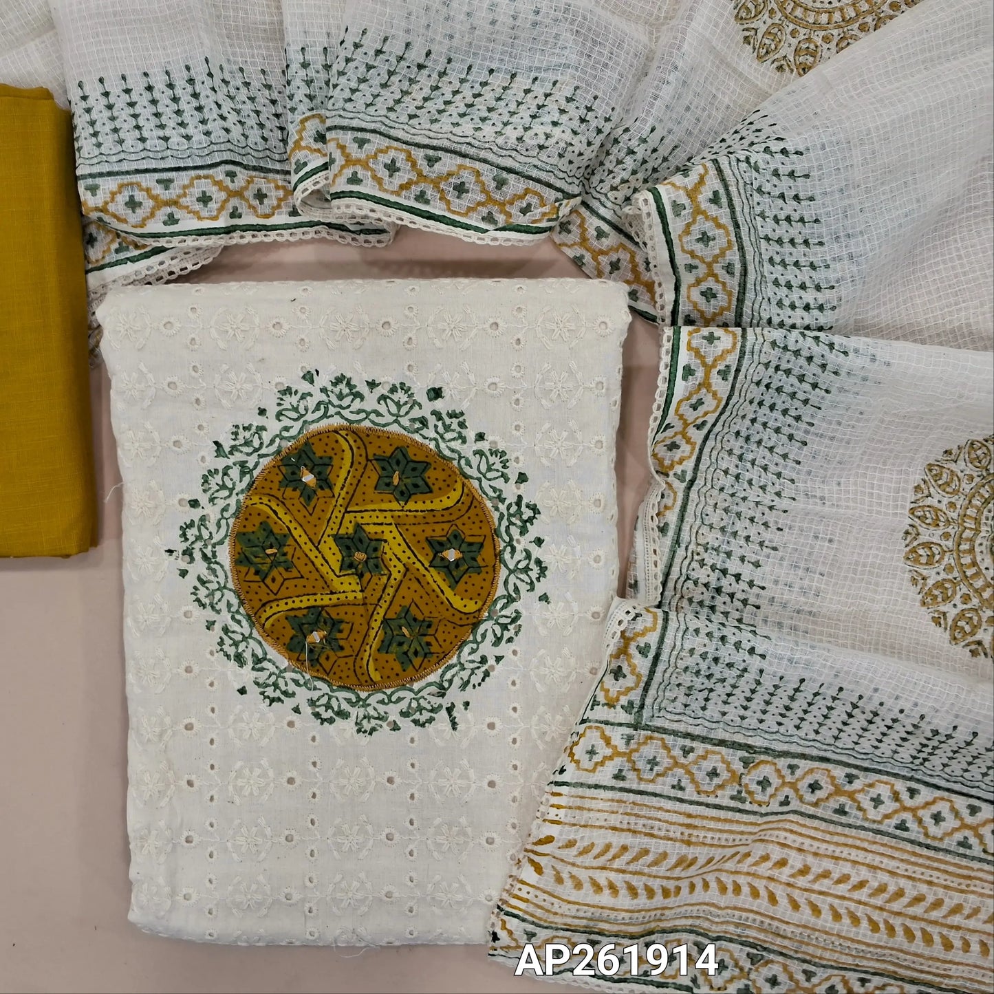 Off white base schiffli embroidered cotton unstitched salwar material (lining needed) ajrak patch yoke with block printed and real mirror,mehandhi yellow cotton bottom, hand block printed,and patch work on kota cotton dupatta with lace taping. AP261914