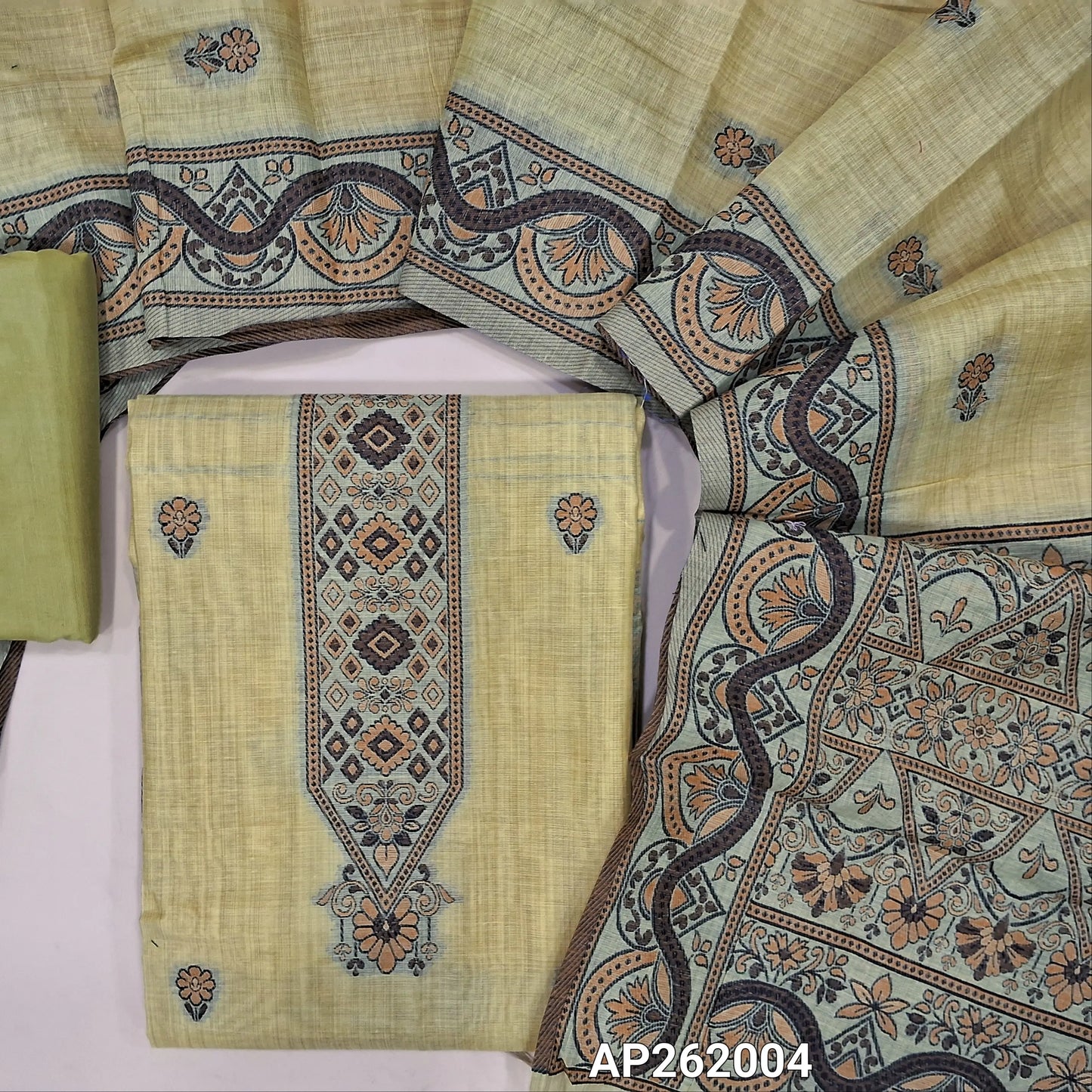 Pastel yellow silk cotton unstitched salwar material,floral buttas on front,thread weaving on yoke and daman,(Silky, Lining Needed)silky bottom, floral buttas on silk cotton dupatta with thread weaving pallu and borders(TAPPING NEEDED). AP262004