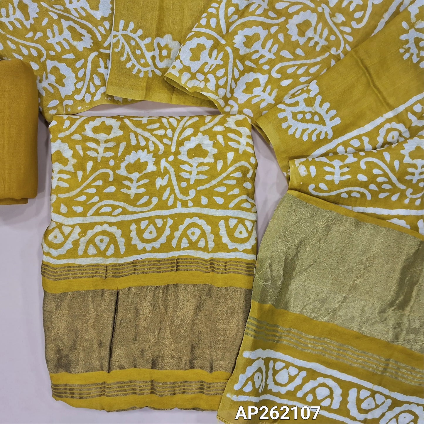 Mehandhi yellow Original wax batik dyed fancy silk cotton unstitched salwar material(lining needed) tissue borders on daman, matching spun cotton bottom, batik dyed fancy silk cotton dupatta with tissue border on pallu. AP262107