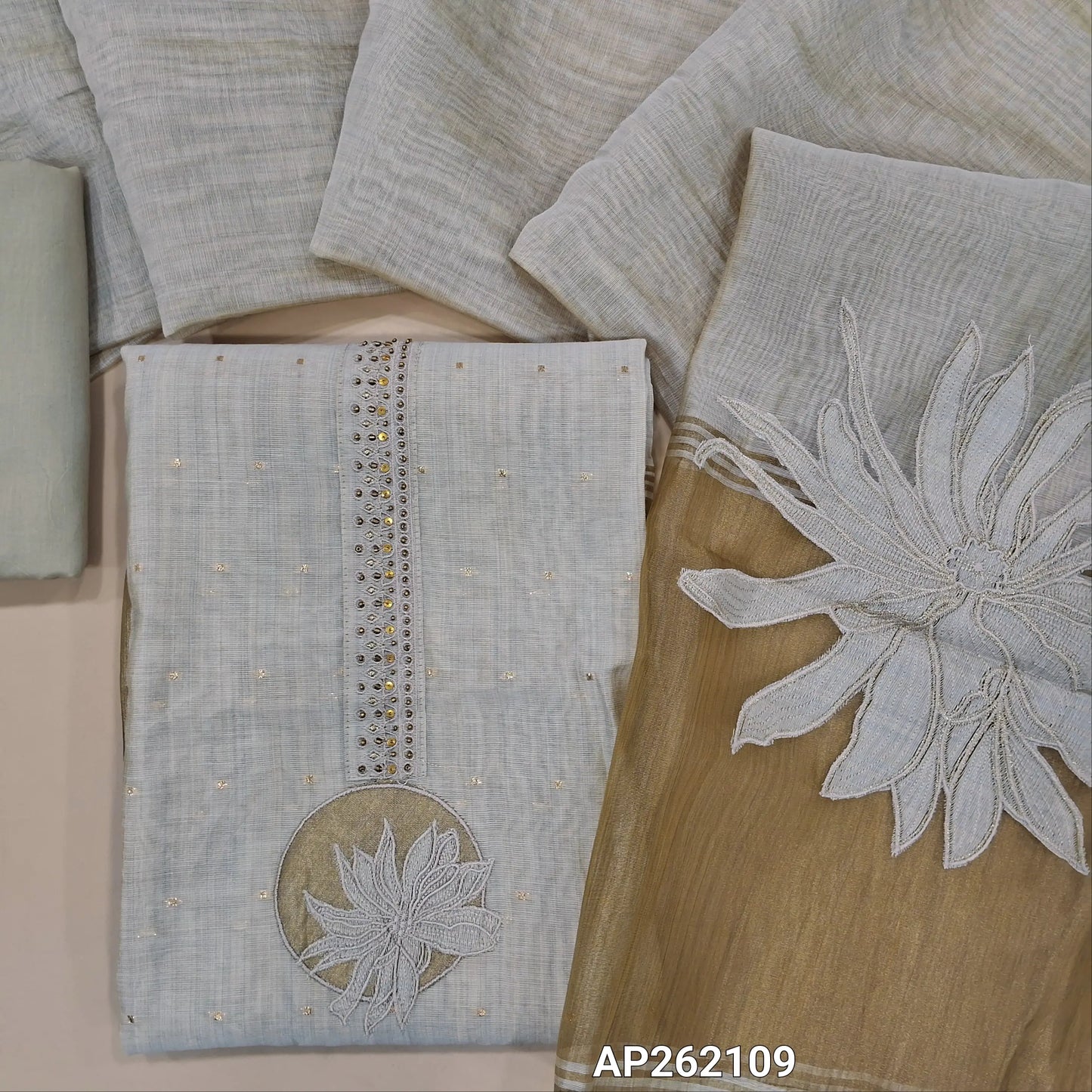 Light beige premium silk cotton unstitched salwar material,bead,antique gold & applique work on yoke(lining needed) zari buttas all over, daman with tissue borders, matching drum dyed cotton bottom, designer premium silk cotton dupatta . AP262109
