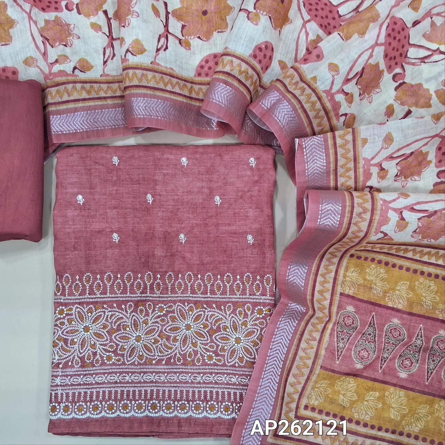 Pink shade abstract printed premium linen unstitched salwar material,floral embroidery work on front( lining needed) rich embroidery work on daman, matching silky bottom, floral printed semi linen dupatta with silver zari borders. AP262121