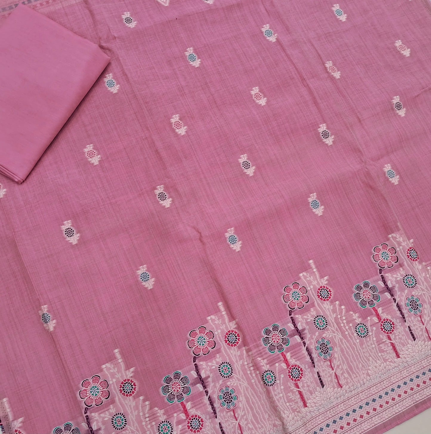 Lotus pink silk cotton unstitched salwar material,thread buttas on front,thread weaving on yoke and daman,(Silky, Lining Needed)matching silky bottom, floral buttas on silk cotton dupatta with thread weaving pallu and borders(TAPPING NEEDED). AP262205
