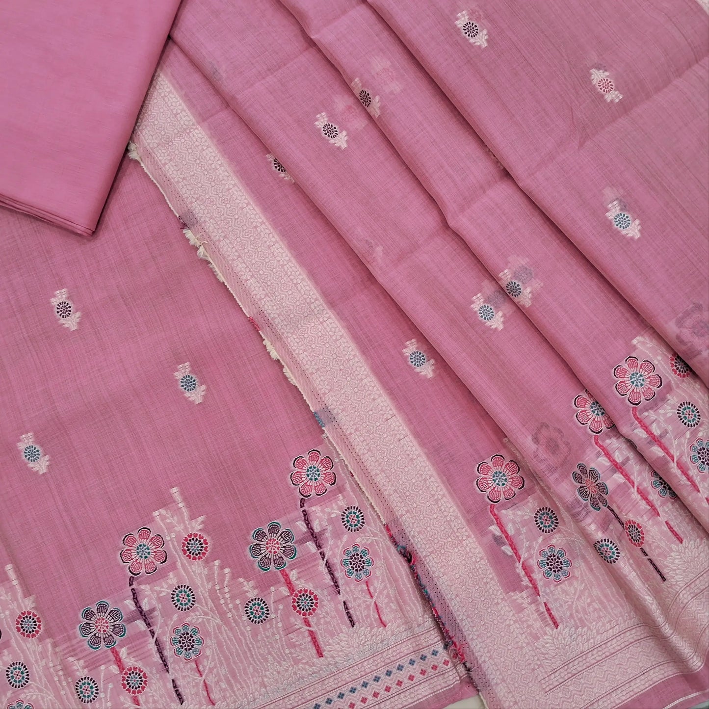Lotus pink silk cotton unstitched salwar material,thread buttas on front,thread weaving on yoke and daman,(Silky, Lining Needed)matching silky bottom, floral buttas on silk cotton dupatta with thread weaving pallu and borders(TAPPING NEEDED). AP262205