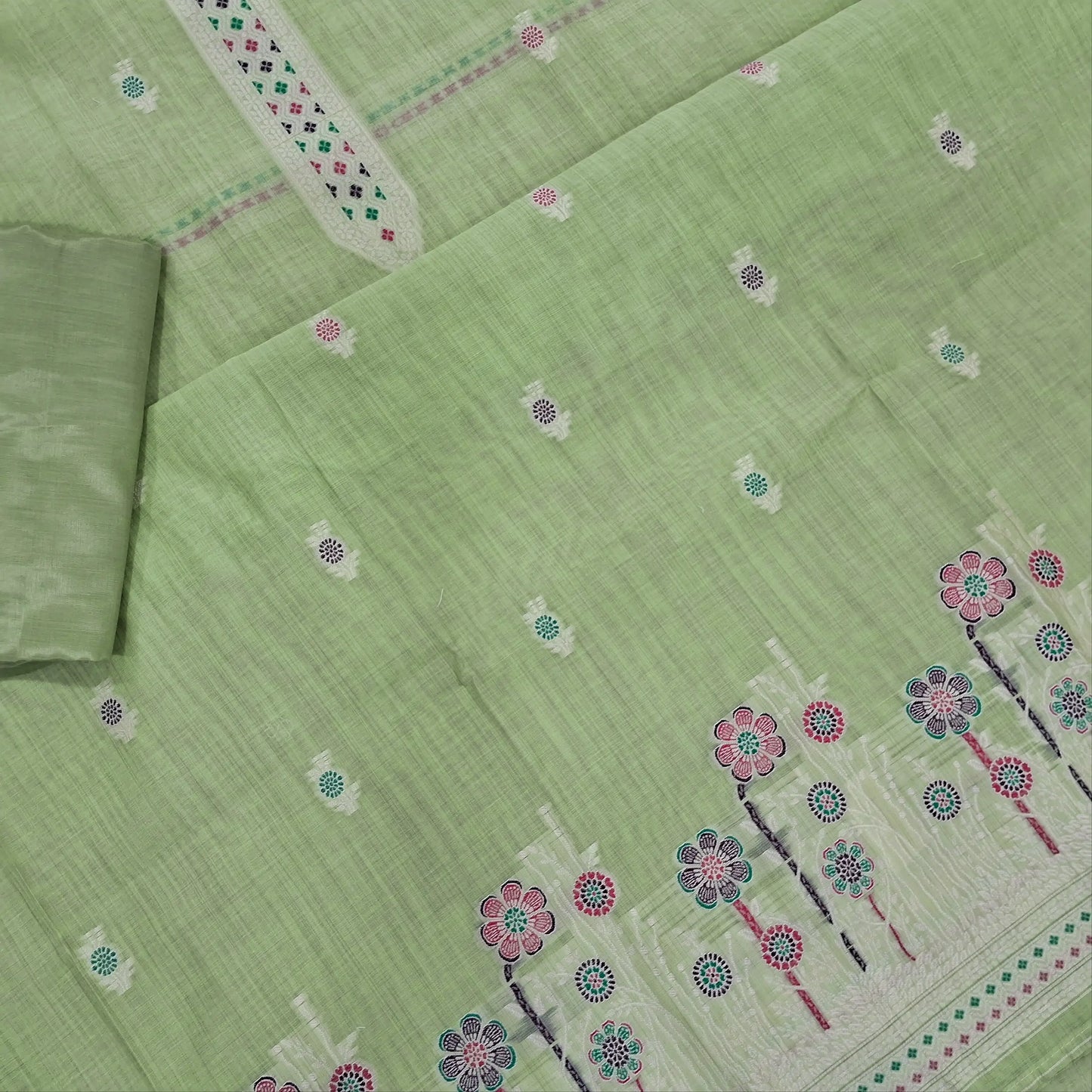 Pastel green silk cotton unstitched salwar material,thread buttas on front,thread weaving on yoke and daman,(Silky, Lining Needed)matching silky bottom, floral buttas on silk cotton dupatta with thread weaving pallu and borders(TAPPING NEEDED). AP262206
