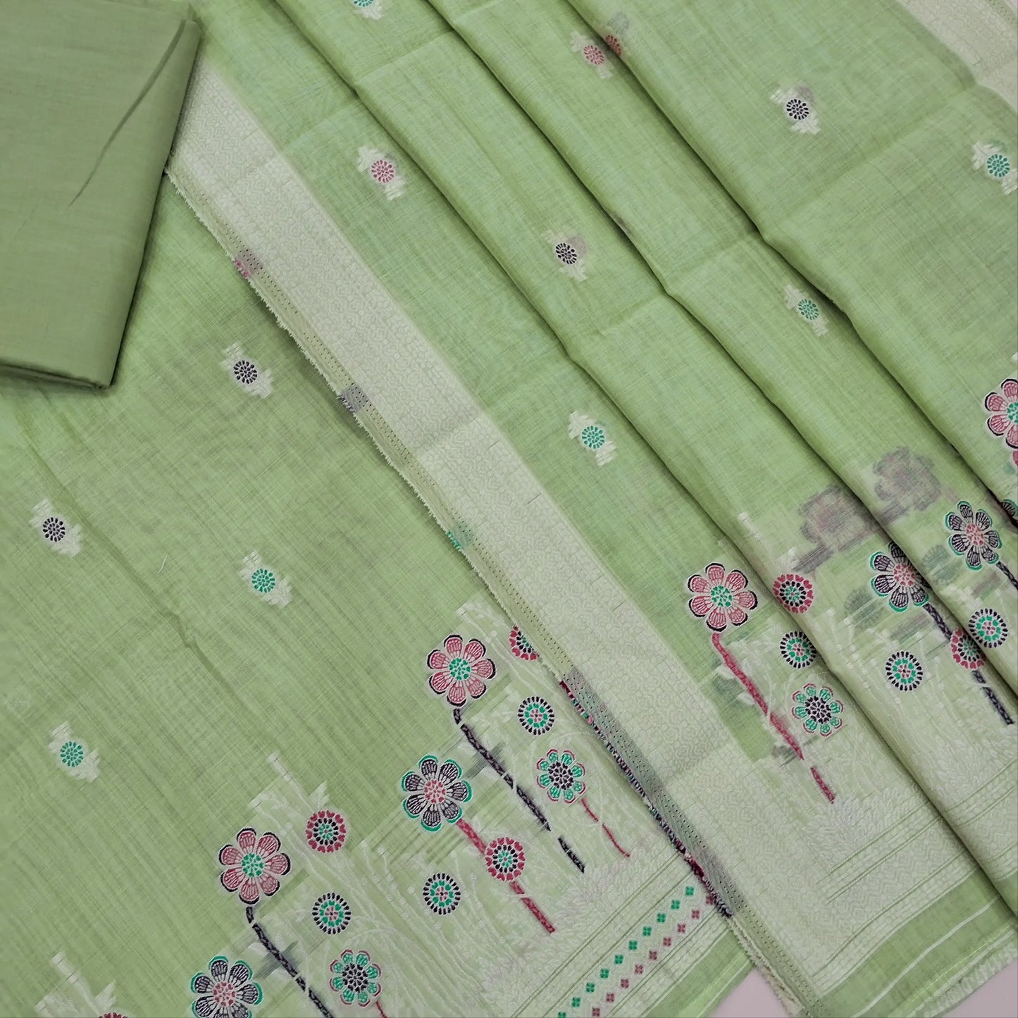 Pastel green silk cotton unstitched salwar material,thread buttas on front,thread weaving on yoke and daman,(Silky, Lining Needed)matching silky bottom, floral buttas on silk cotton dupatta with thread weaving pallu and borders(TAPPING NEEDED). AP262206