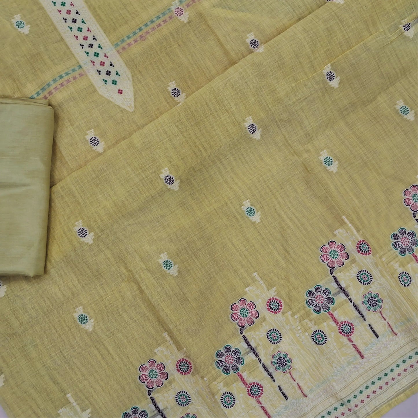 Pastel yellow silk cotton unstitched salwar material,thread buttas on front,thread weaving on yoke and daman,(Silky, Lining Needed)matching silky bottom, floral buttas on silk cotton dupatta with thread weaving pallu and borders(TAPPING NEEDED). AP262208