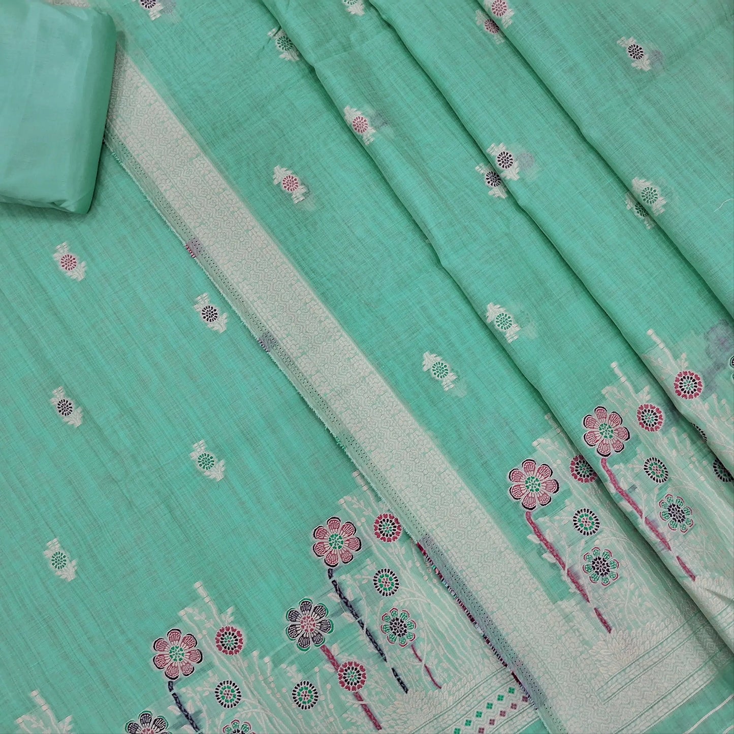 Pastel blue silk cotton unstitched salwar material,thread buttas on front,thread weaving on yoke and daman,(Silky, Lining Needed)matching silky bottom, floral buttas on silk cotton dupatta with thread weaving pallu and borders(TAPPING NEEDED). AP262204