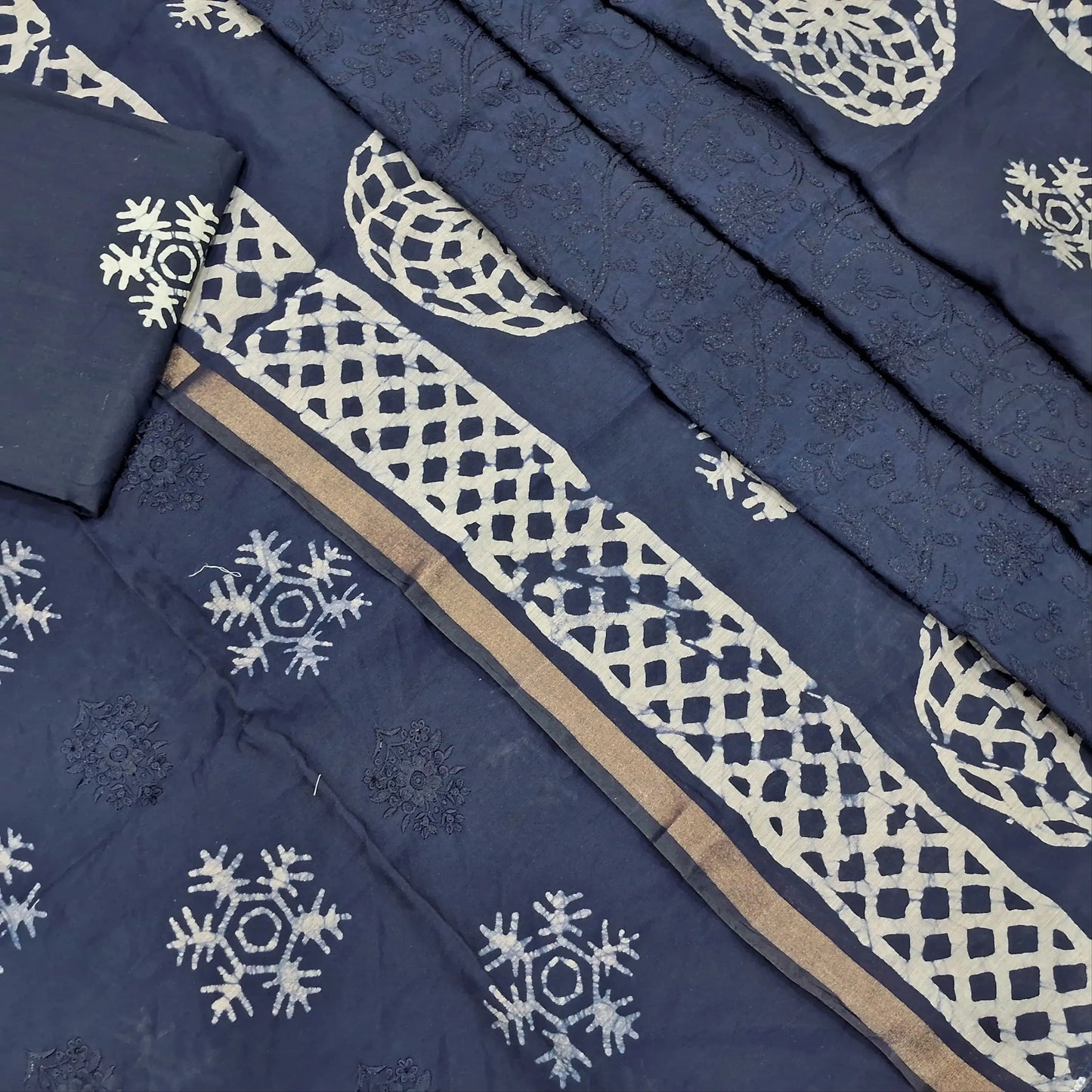 Dark blue premium silk cotton unstitched salwar material(lining needed)self embroidery work on front, batik design all over, wax batik cotton bottom, self embroidery and batik design on silk cotton dupatta with tissue borders.AP262210
